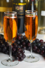 Two flutes of champagen or wine in a bar