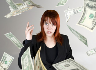 Angry and pretty redhead girl throwing Dollar banknote money