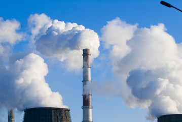 Industrial smoke on a background of the blue sky