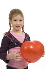 a little girl with a heart shape balloon