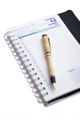 agenda with wooden pen isolated on white background