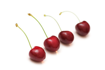 Row of cherries isolated on the white.
