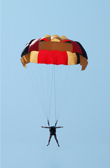 Multi coloured parachute over the blue sky