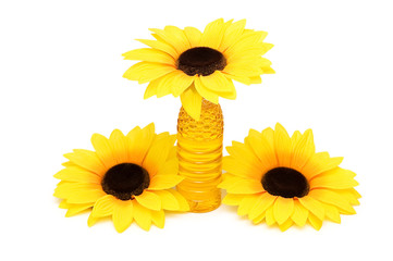 Naklejka premium Three sunflowers and bottle of oil isolated on white