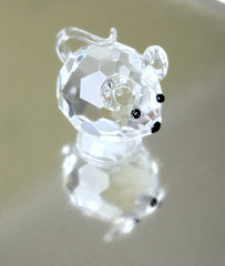 A small souvenir in the form of a glass mousy. Reflection
