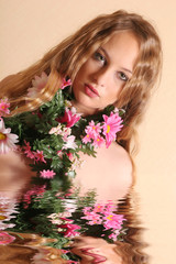 Sexy young blond woman with flowers