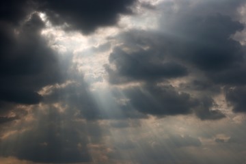 Rays of light shining throug dark clouds