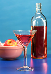 A cosmo martini with a blue background for cocktial time