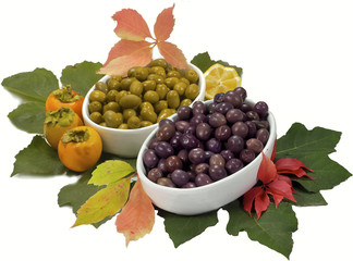 trays of green and brown olives, isolated on white background