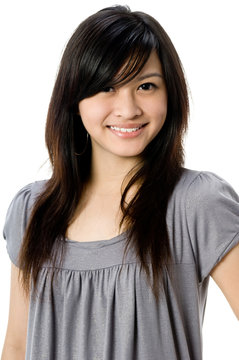 A cute young Asian woman in grey dress on white background