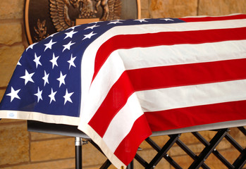 The coffin of a veteran draped with the American Flag