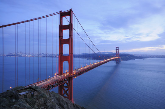 Traffic along the glowing Golden Gate Bridge