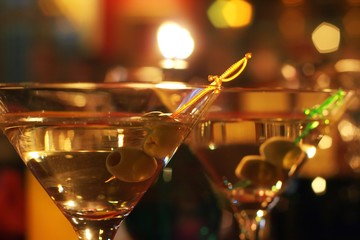 Olive and glass Martini with candle - shallow dof
