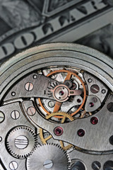 Analog clock mehanics with dollars on background