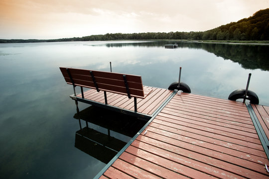 Twilight landscape with dock on small lake