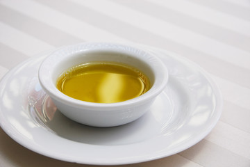 Golden Olive Oil on White Tablecloth