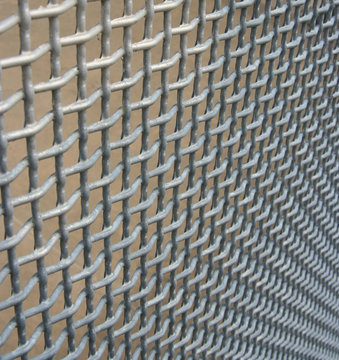 Wire mesh fencing material vanishing into the corner 