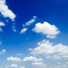 Naklejka na ściany i meble The blue sky is covered by white fluffy clouds.