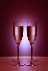 Valentine couple champaigne glasses with red light