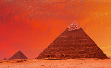 Obraz na płótnie Canvas Starożytne egipskie piramidy w czerwony zachód słońca