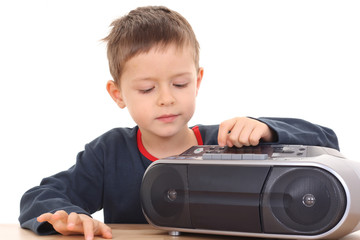 Fototapeta na wymiar cute 6 years old boy listening to music isolated on white