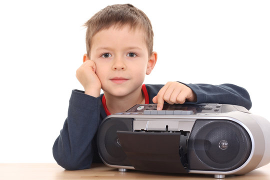 cute 6 years old boy listening to music isolated on white