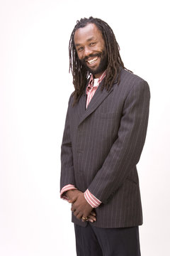 A black man with dreadlock hair isolated on a white background.