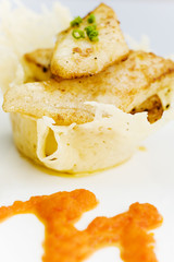 White fish on the cheese basket with pepper dressing