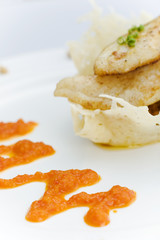 White fish on the cheese basket with pepper dressing 