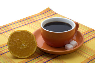 cup of coffee with an orange on a serviette