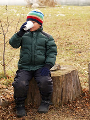 young boy drinking hot chocolate