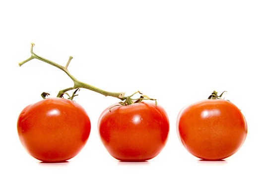 three red tomatos on the white background