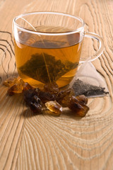 white tea, nylon tea-bag and brown sugar on the old wood