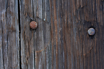 a macro picture of old wood and nail