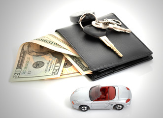 Car keys on a leather wallet with money