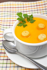 Carrots puree with parsley, on white cup. Shallow DOF