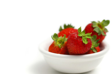 Strawberries in a bowl isolated on white