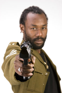 A Black man in a Army jacket with a gun