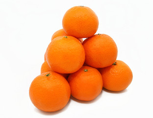 Pyramid from tasty ripe tangerines on a white background.