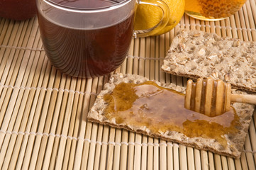 sweet breakfast ingredients - bread, honey, fruits, tea