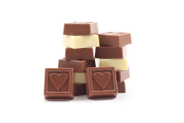 stack of delicious chocolates with heart isolated on white