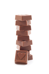 stack of delicious chocolates with heart isolated on white