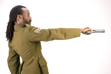A Black man in a Army jacket with a gun 