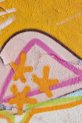 Detail of a colorful graffiti with three stars