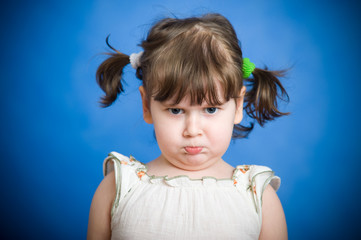 Angry kid on blue background