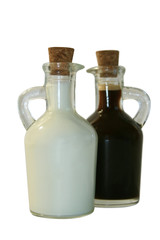 Two small decanters whith milk and coffee. 