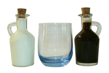 Two small decanters whith milk and coffee.