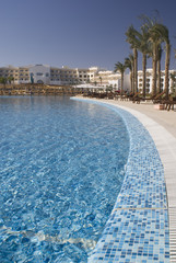 Swimming pool view in the hotel and palm trees