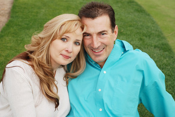 Fototapeta premium happy couple is smiling in green park environment