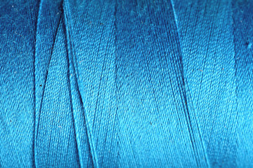 blue thread fabric wool yarn wrapped in a spool
